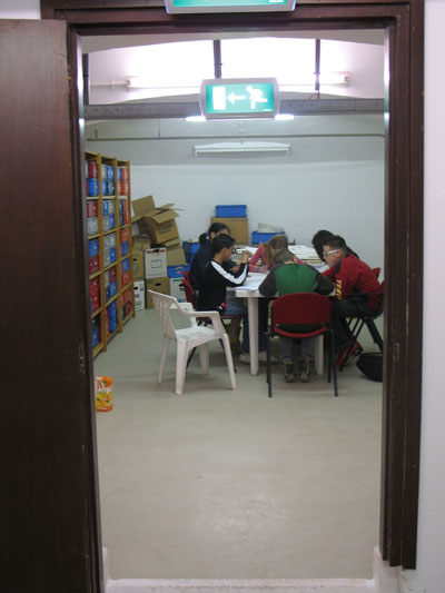 Fig 19 : The pupils that are part of the development panel at work in one of the basement rooms.